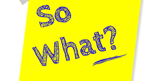 A yellow post-it note with the words "So what?" written on it in blue ink